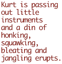 Kurt is passing out little instruments and a din of honking, squawking, bleating and jangling erupts.